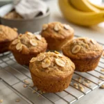 Freshly baked banana oatmeal muffins on a cooling rack