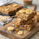 Close-up of peanut butter banana oatmeal bars stacked on board